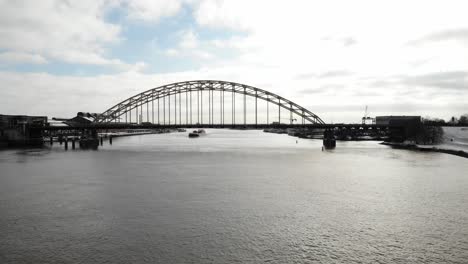 Aerial-view-of-road-bridge-over-a-river-in-industrial-urban-area