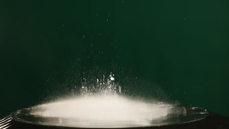 jumping flour on moving subwoofer on green background