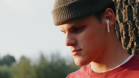 young man listening to music outdoors