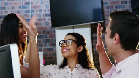 business executives giving high five to each other