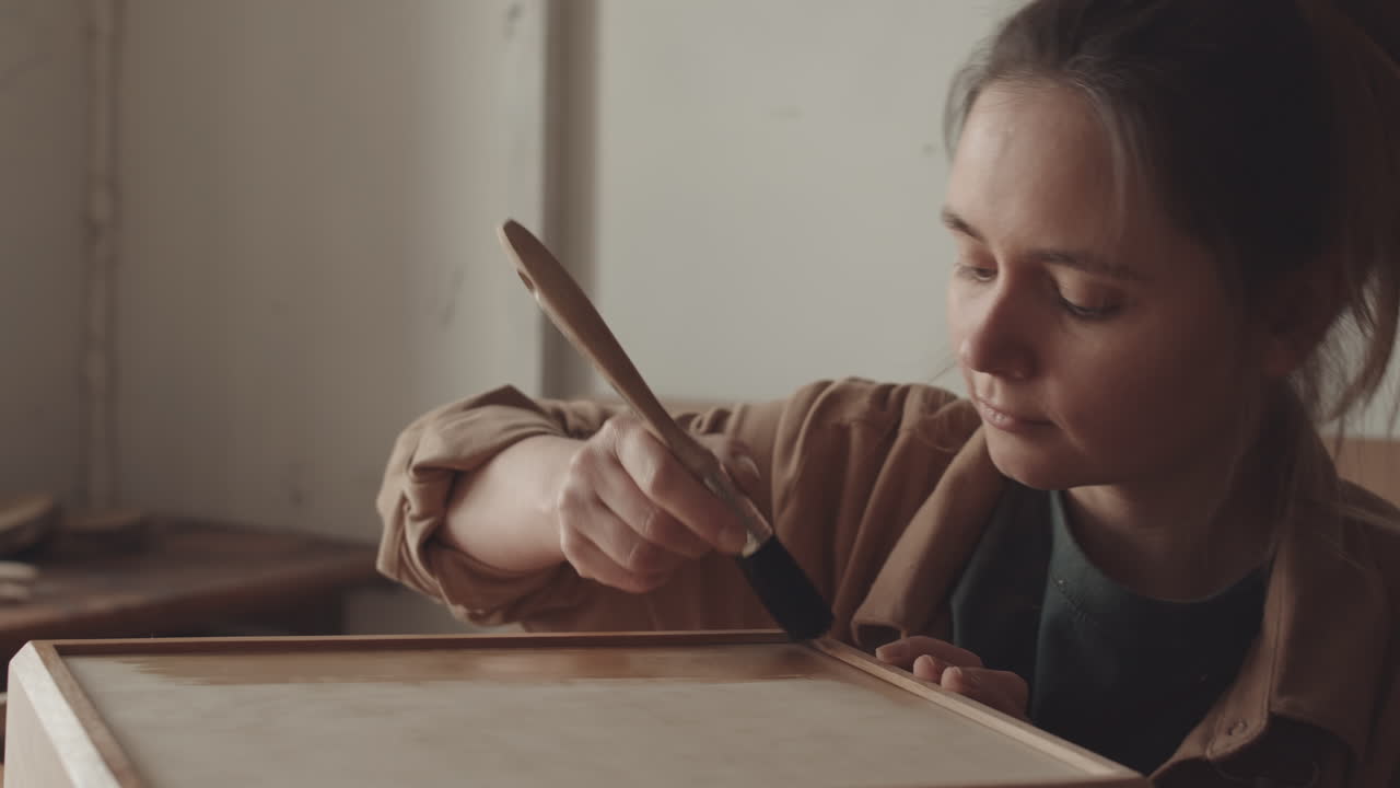 Handywoman Applying Wood Varnish on Wooden Box