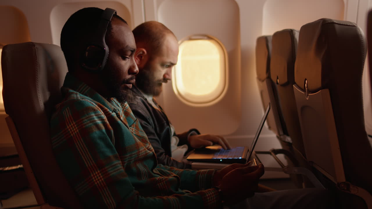 Tourist using mobile phone and flying on airplane jet