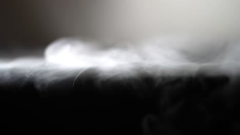 Cold-white-smoke-or-atmospheric-fog-drips-over-leather-surface-with-cold-dew-drops