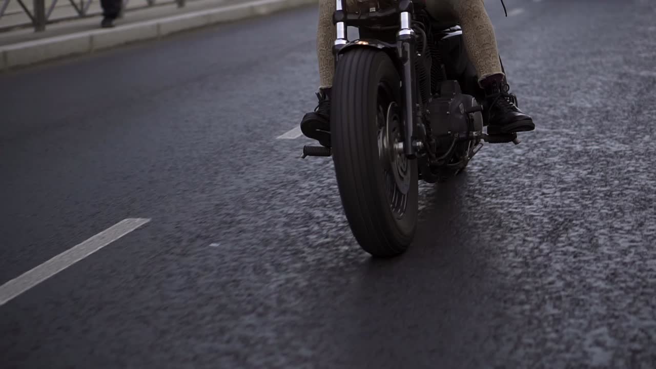Unrecognizable motorcyclist drives a bike in the city