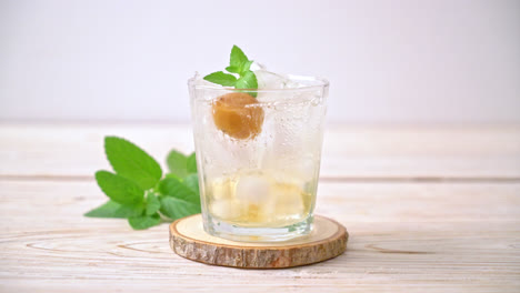 pouring-soda-in-glass-with-plum-juice-and-mint