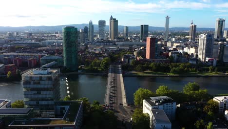 wide angle flyover above cars commuting into downtown frankfurt germany at midday