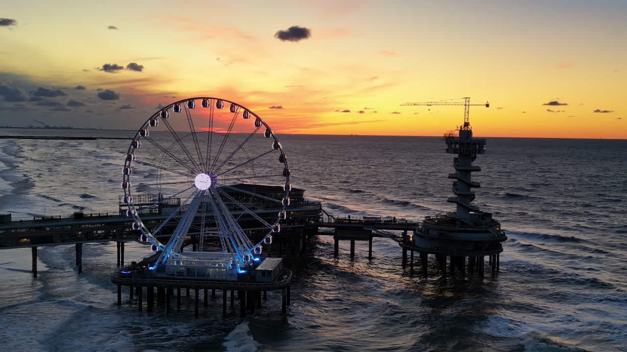 The Hague, Netherlands - November 21, 2024: Aerial drone view of the Scheveningen Pier and Ferris Wheel at the Dutch North Sea Coast