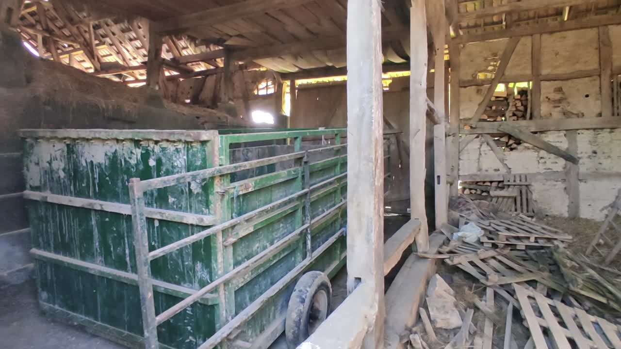 The inside of an old run down barn in Alsace, France. Panning shot.