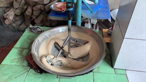 Close-up-shots-of-an-industrial-mixing-machine-mixes-a-concoction-of-ingredients-to-make-coconut-candy-in-processing-area-in-Vietnam