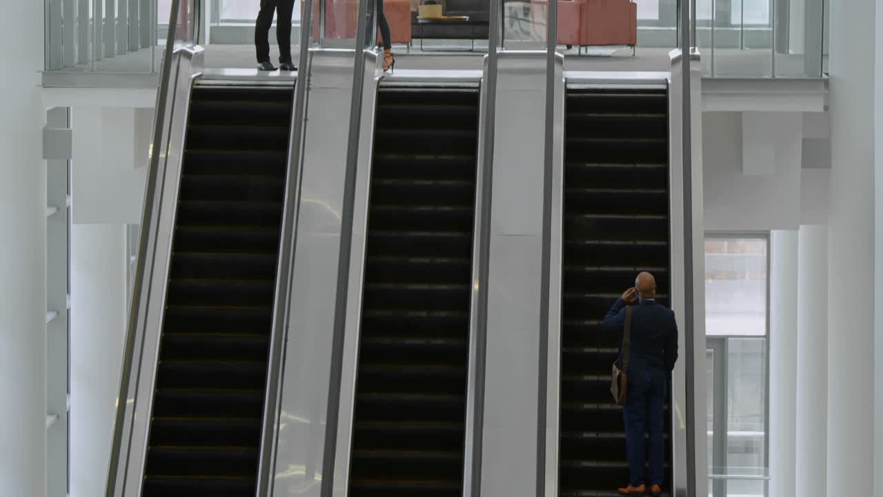 Business people using escalator 4k