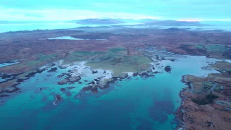 Aerial-view-of-Erraid-Island-in-Scotland,-turquoise-clear-blue-water,-day