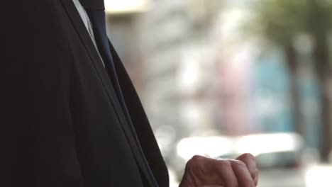 handsome businessman texting on his phone