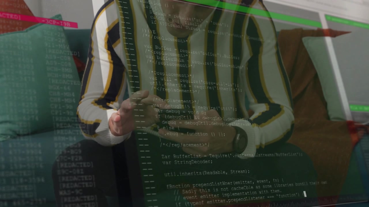 Mid-adult male on teal sofa in striped sweater tapping smartphone, smartwatch and code overlay