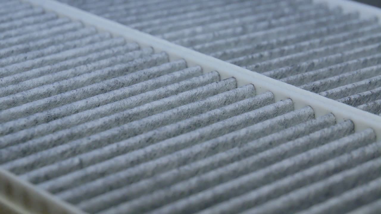 Close-Up Of A Carbon Charcoal Cabin Car Air Filters Rotating On A Turntable In The Dark