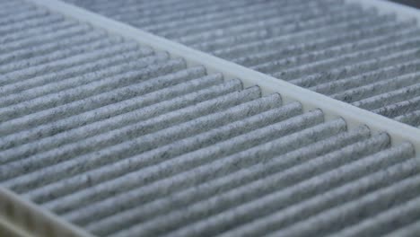 close-up of a carbon charcoal cabin car air filters rotating on a turntable in the dark