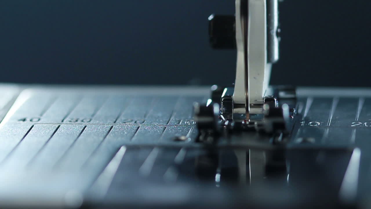 Manufacturing equipment at textile factory. Sewing needle in slow motion