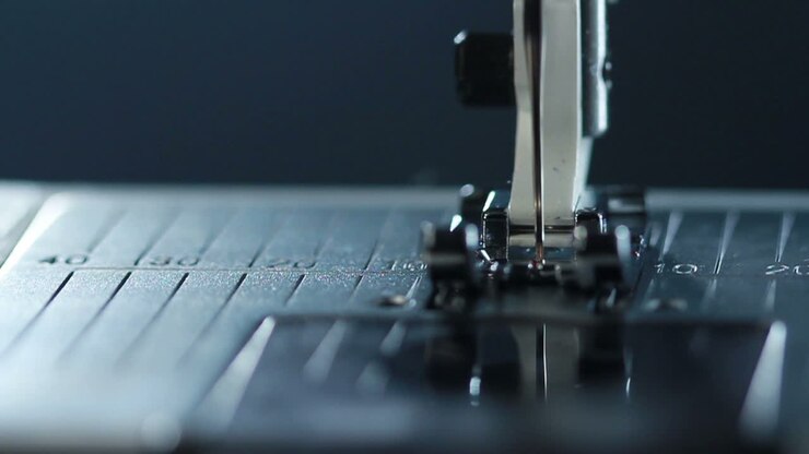 Manufacturing equipment at textile factory. Sewing needle in slow motion