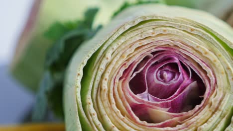 Cut-fresh-artichokes-on-plate,-rotating.-Closeup.-Nobody