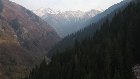 cinematic drone footage flying through a valley towards the trans-ili alatau mountains in kazakhstan