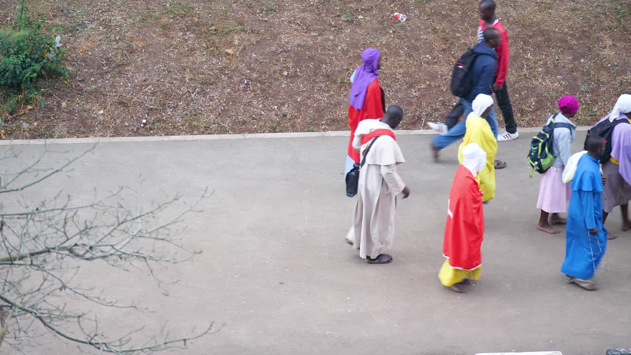 A Group of Christians march on the road of Nairobi Kenya to attend their religious gathering to be held in the morning , many people together