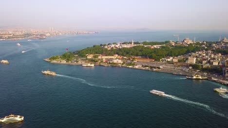 Boats-sailing-in-Golden-Horn,-Bosphorus-Strait,-Sultanahmet-in-background