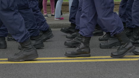 soldiers march together on a street