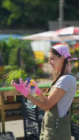 woman watering plants in a garden center