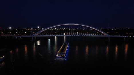 night aerial shot of a modern apollo bridge across river danube in bratislava, slovakia