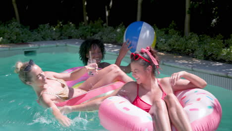 woman relaxing on pool float, enjoying sunny day with refreshing drink