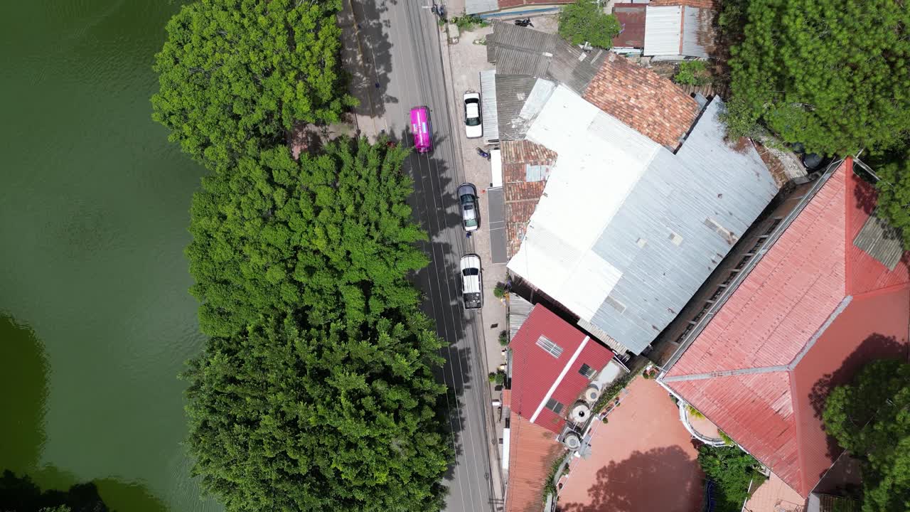 Drone top view urban street and green lake in Santa Lucia, Honduras, cultural tourism