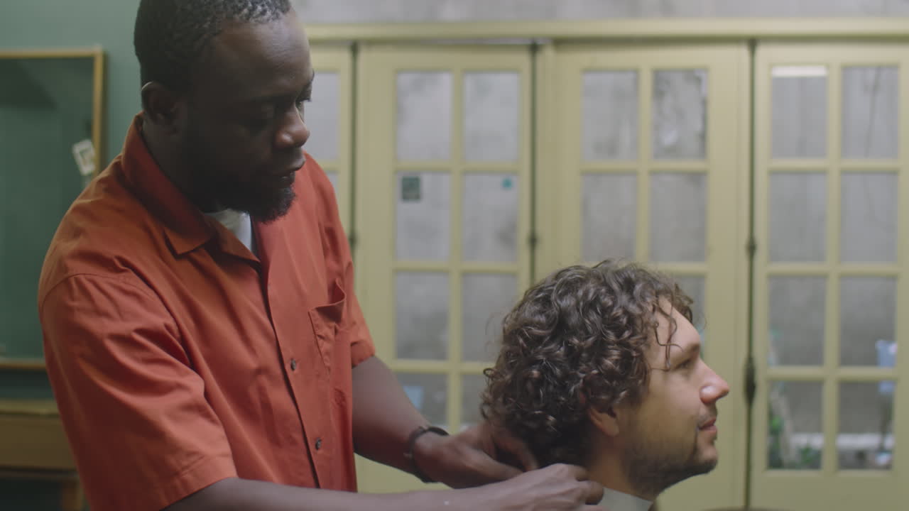 Barber Putting Neck Tape and Hairdressing Cape on Male Client