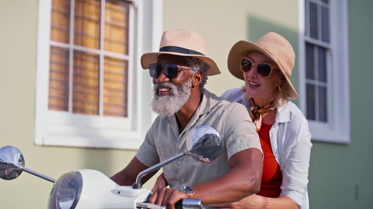 Senior couple riding a moped
