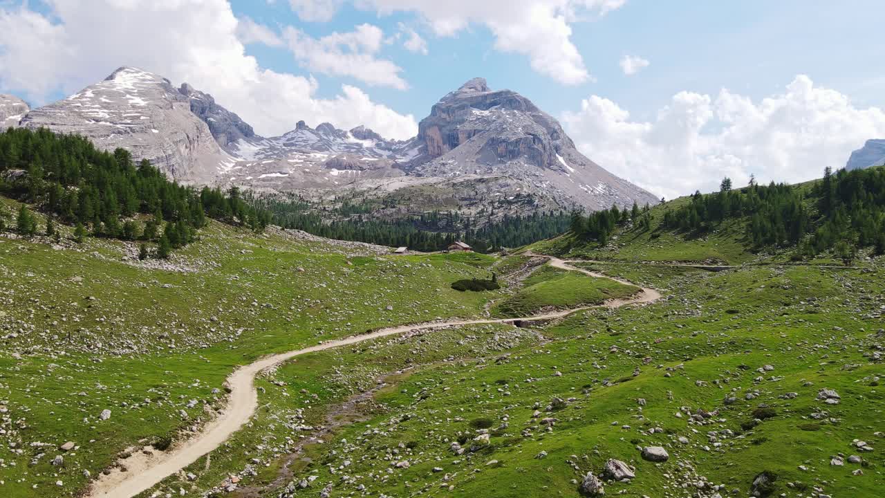 Stunning summer of scenic dirt road cutting through alpine valley in Dolomites