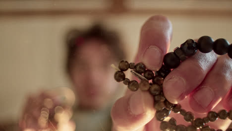 close-up of a person crafting beaded jewelry