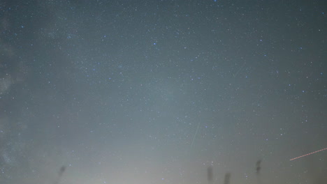 starry night sky with a visible meteor trail, captured in a clear, time-lapse shot