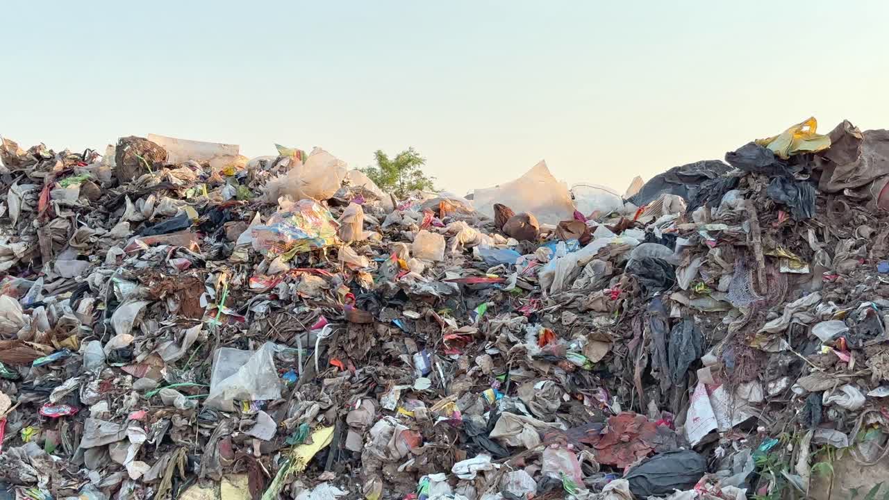 static shot of a pile of garbage at the dump yard filled with waste plastic which is the main casue of microplastic pollution