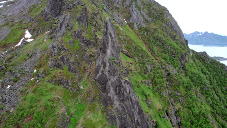 Aerial-view-in-orbit-over-the-rocky-pinnacle-of-Svolvaergeita-in-spring