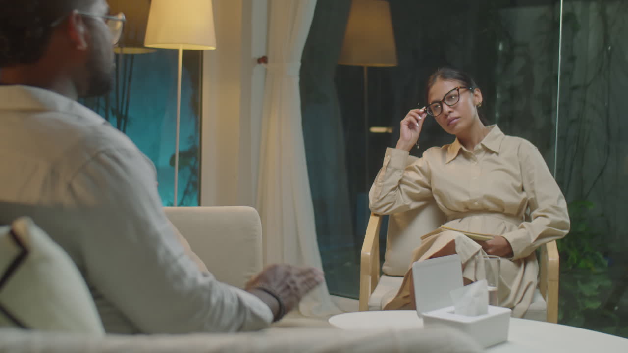 Asian Female Therapist Listening to Patient on Counseling Session