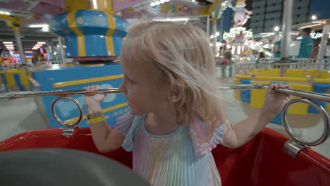 delighted child in merry-go-round at night