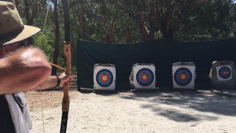 australian man archer aiming to target