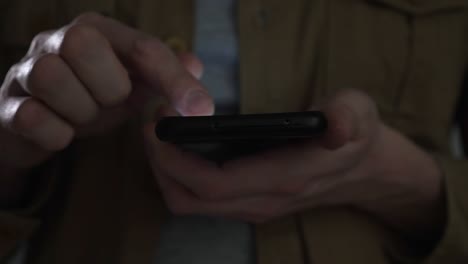 man touches scroll page app on mobile phone, browsing movie video in the internet library to watch film online