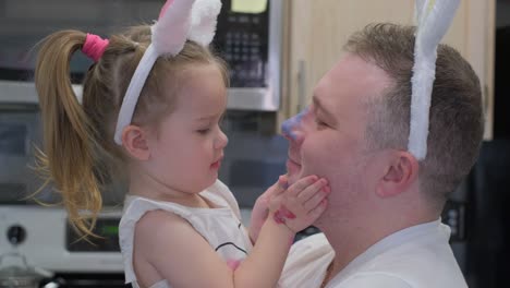 dad with daughter in bunny ears on easter holiday. close-up