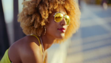 Smiling-Girl-with-Afro-Resting-on-Promenade