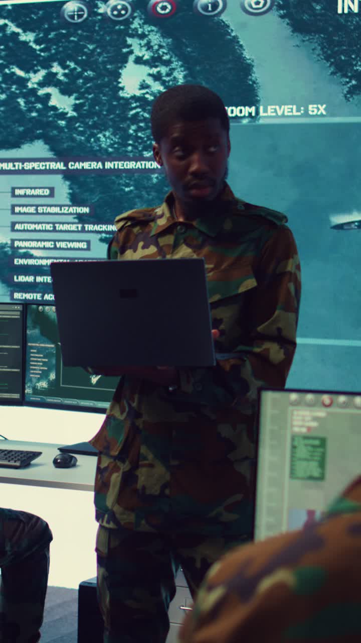 Soldier in Camouflage Uniform Working on Laptop in Control Room
