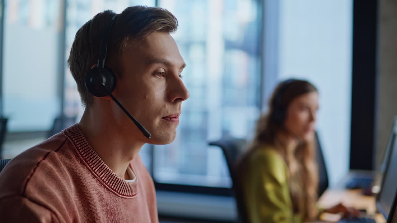 Agent hand taking headset from monitor closeup. Hotline managers talking on call