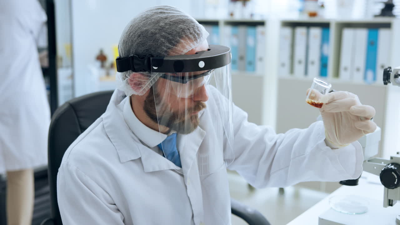 Male Scientist in Protective Gear Working with Liquids in a Laboratory