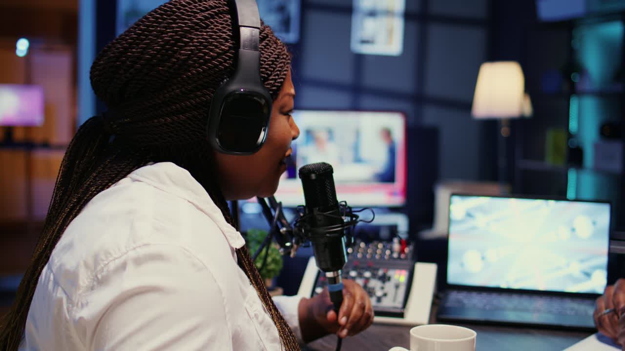 Influencer in studio using high tech microphone for online show on livestreaming channel