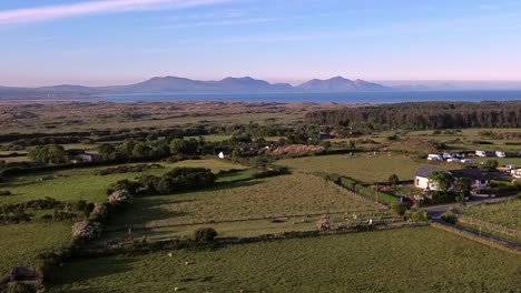 idyllic welsh meadow under snowdonia mountains aerial rising view over rural eryri national park