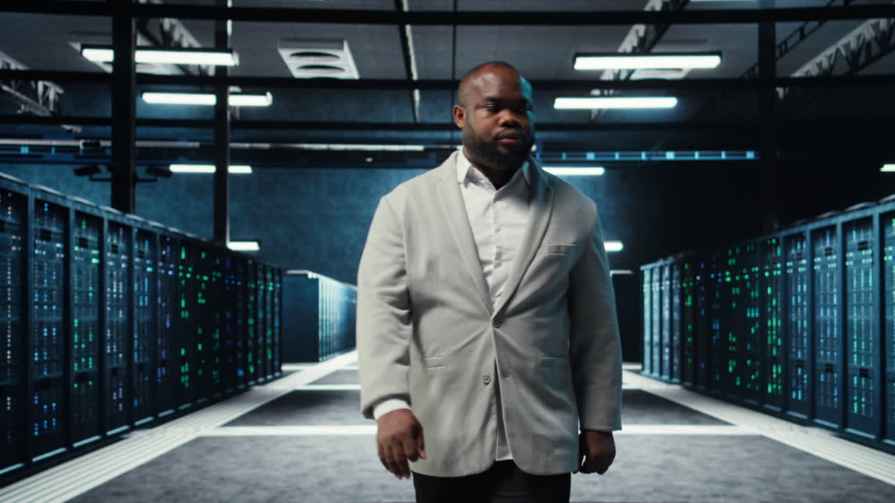 Vertical video Employee walking in data center with blinking lights on rigs