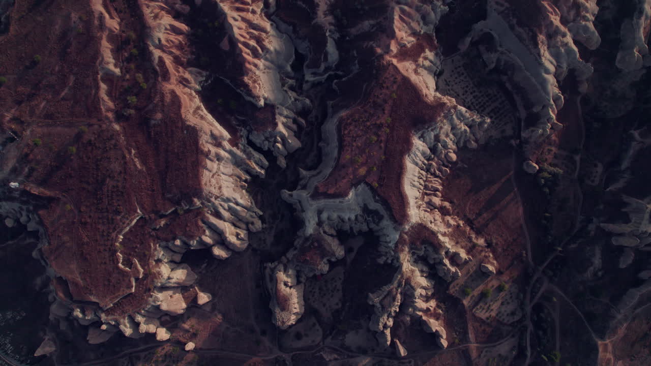 Aerial top-down view of Cappadocia rugged terrain with rock formations
